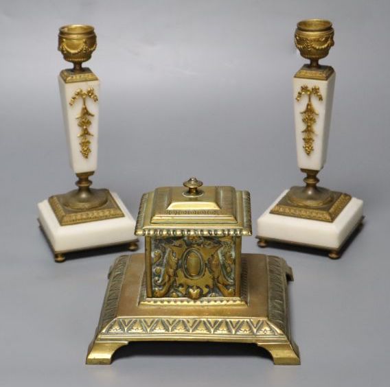A pair of ormolu mounted alabaster candlesticks, 18cm and a cast brass inkwell with ceramic liner, 14cm wide